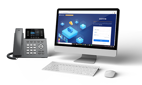 Interface de connexion GDMS sur un moniteur d’ordinateur aux côtés d’un téléphone de bureau professionnel